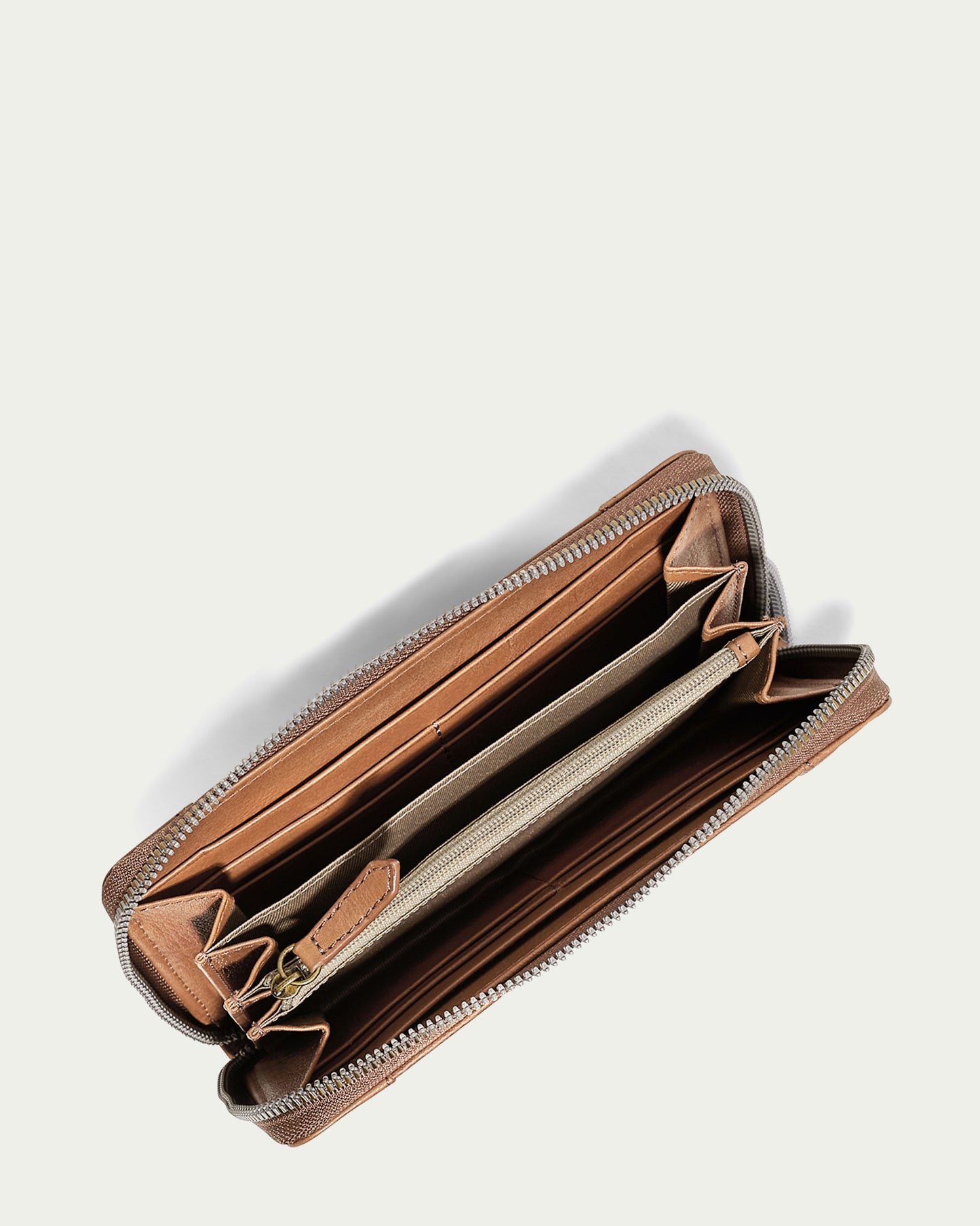 The Austin Continental Wallet by American Leather Co. is an open brown leather wallet with a zipper, card slots, and compartments. It includes RFID protection and has an empty interior against an off-white background.