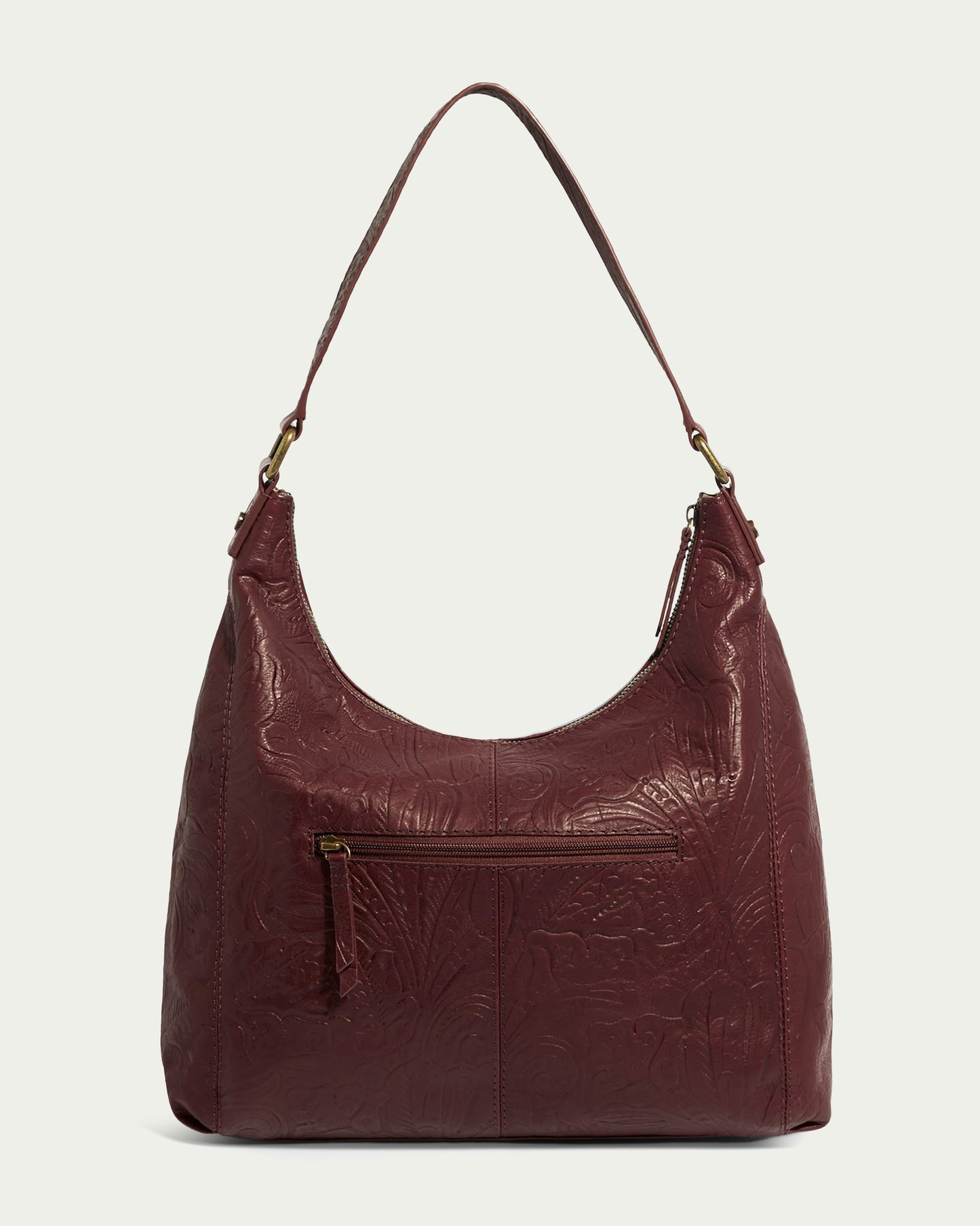 The Blake Hobo by American Leather Co. is a maroon, embossed leather hobo bag featuring a shoulder strap and front zip pocket, showcased against a light background.