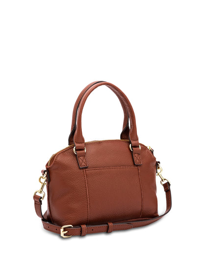 The Carrie Mini Dome Crossbody from American Leather Co. is a stylish, brown leather handbag with gold-tone hardware, featuring two short handles and a detachable crossbody strap. Made from genuine leather, it includes a zipper closure on top and a flat base. One side boasts a simple, unadorned pocket, enhancing its minimalistic design.