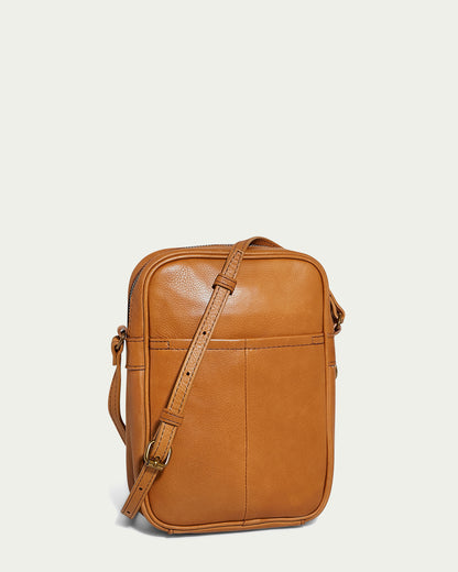 The Cleveland Large NS Crossbody by American Leather Co. is expertly crafted from genuine American glove leather, showcasing a sleek rectangular design with an adjustable strap. Positioned on a plain white background, it features detailed stitching on the front pocket that elevates its elegant charm.