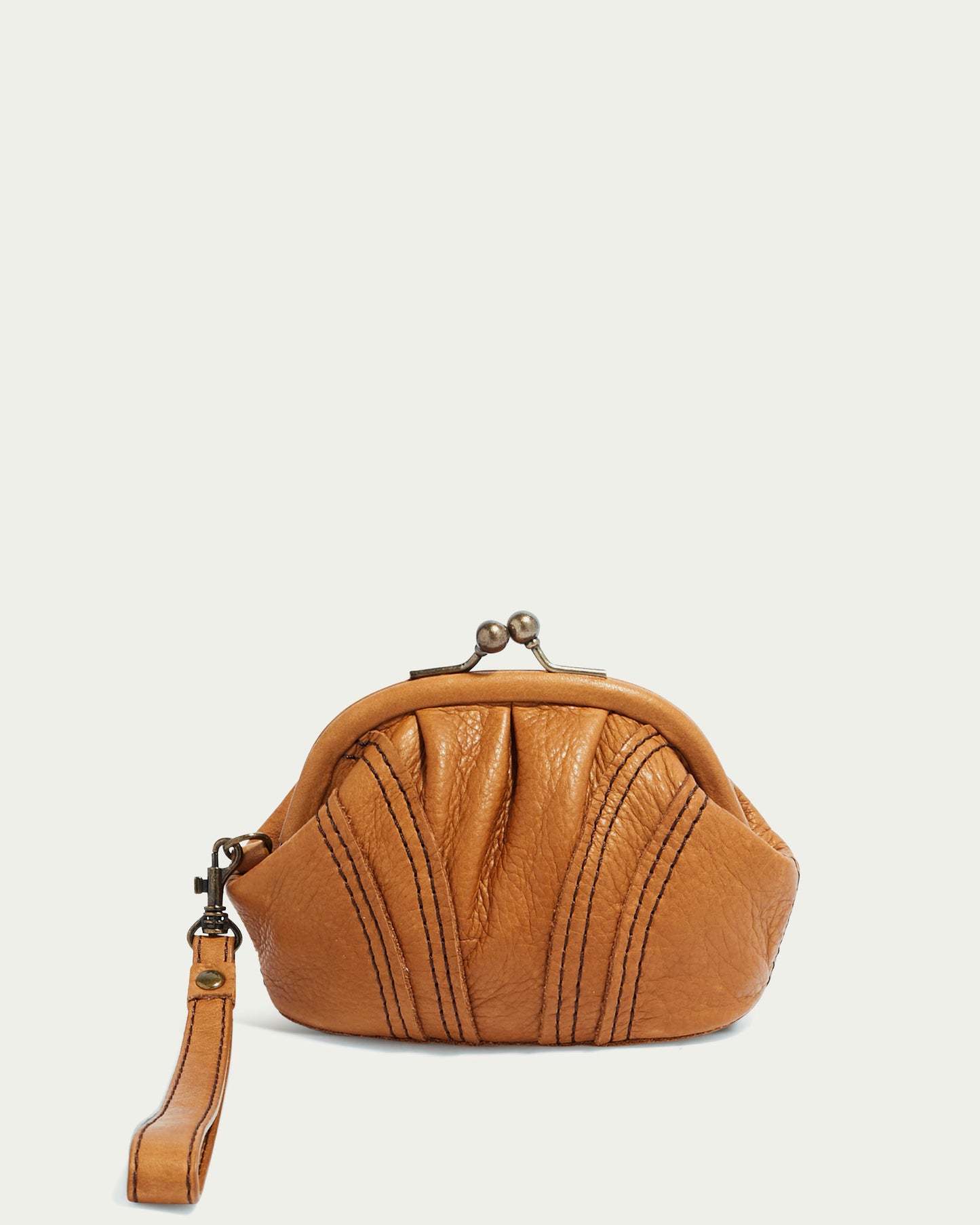 The Dora Frame Coin Wristlet by American Leather Co. is a vintage-inspired brown leather purse with a kiss-lock clasp and side strap, featuring decorative stitching on a textured surface against a plain background.