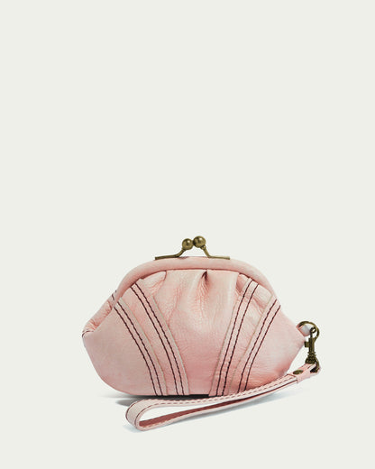 A petite, light pink leather Dora Frame Coin Wristlet by American Leather Co. boasts genuine glove leather, a gold clasp, and a vintage-inspired wristlet. It features fan-like stitched details on a plain backdrop for an elegant look.