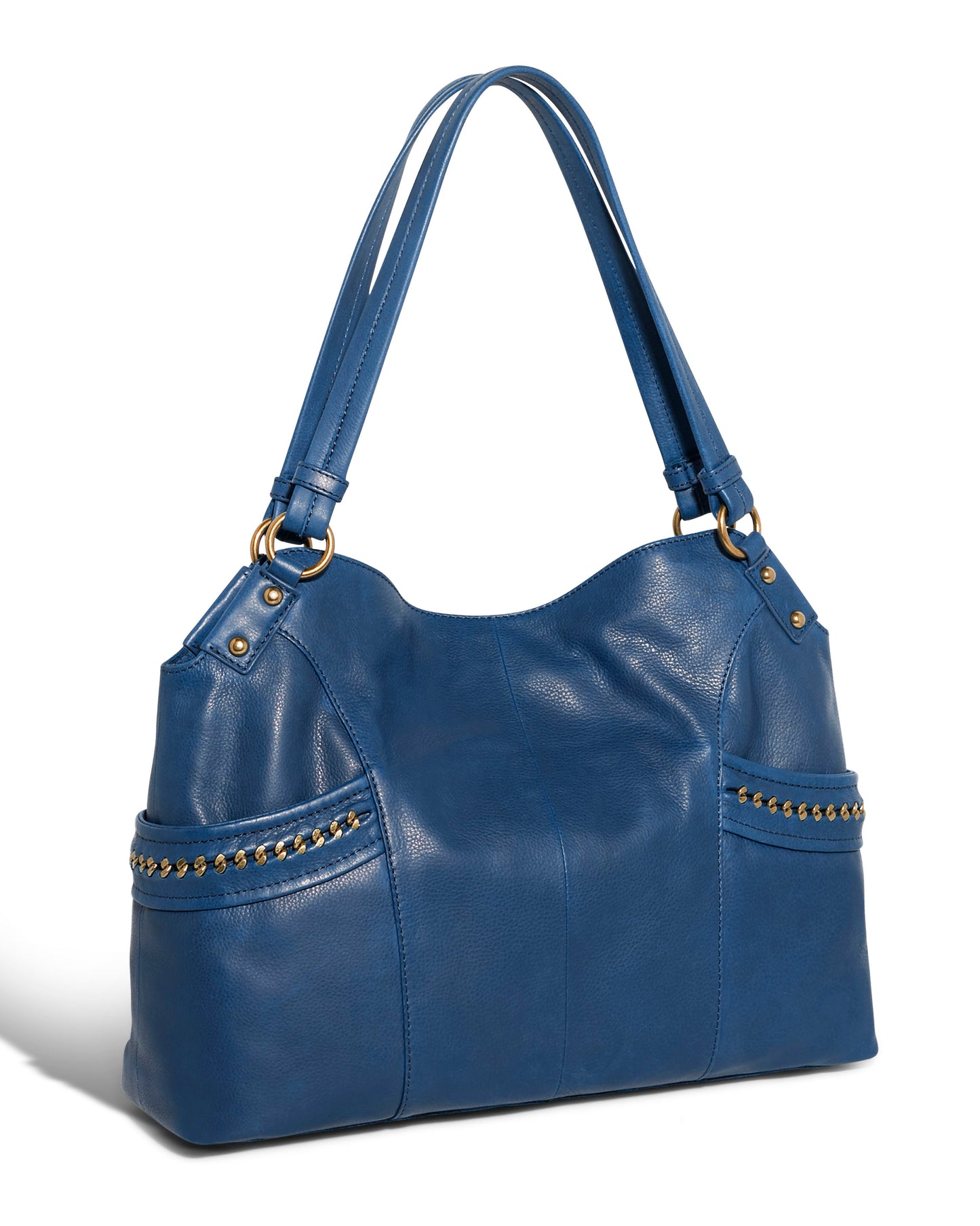 Introducing the American Leather Co. Sumner Satchel: a chic blue leather handbag made from genuine American leather, highlighted with gold stud accents on the side pockets. It boasts two shoulder straps and a sleek, structured finish, all set against a white background.