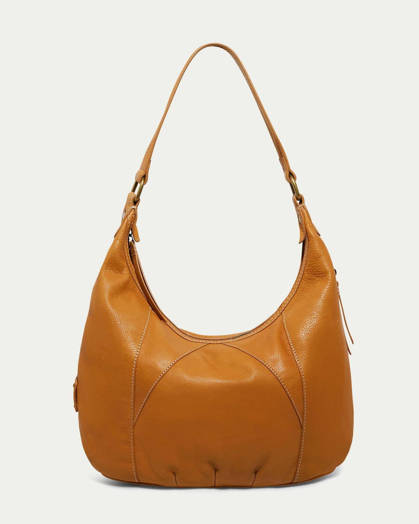 Introducing the Vino Bucket Hobo by American Leather Co., a tan leather hobo bag expertly crafted from genuine American leather. This elegant piece features a single strap and subtle stitching, offering a smooth texture and crescent shape that embody timeless style. It's an ideal choice for both casual and formal occasions.