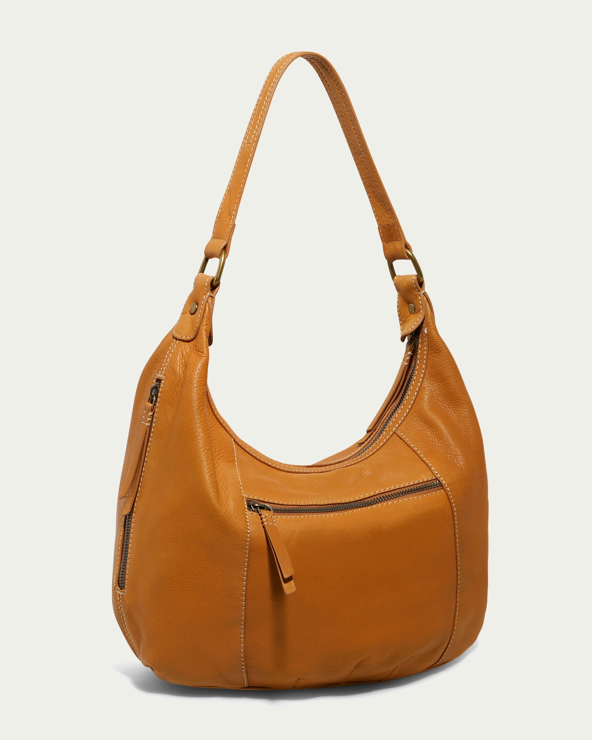 The Vino Bucket Hobo from American Leather Co. combines timeless style with a gracefully curved silhouette, featuring a front zipper pocket and two decorative zippers on each side. Crafted from genuine American leather, it boasts an adjustable strap and a soft, textured finish.