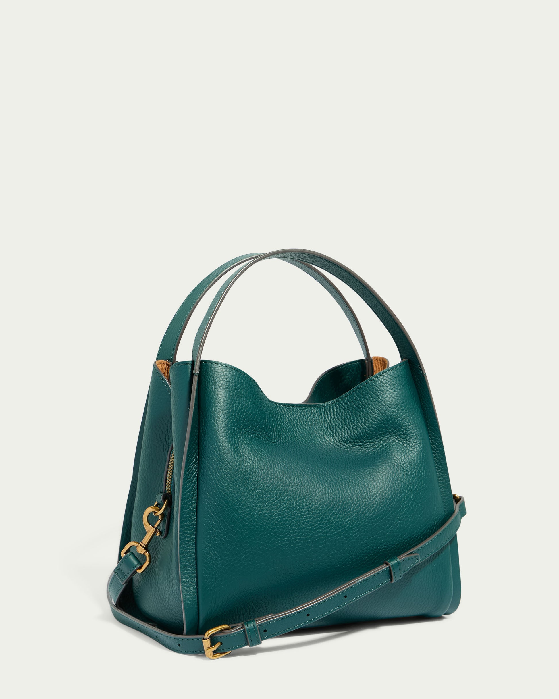 The Auburn Triple Compartment Convertible Crossbody by American Leather Co. is a stylish dark green genuine leather handbag with a structured design. It features two short handles, a triple entry layout, and a detachable, adjustable shoulder strap. The bag is accented with weather-proof gold-tone hardware and visible stitching along the edges against a solid light-colored background.