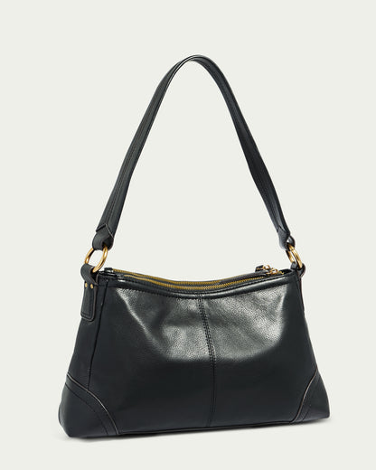 The Becket Triple Entry Shoulder by American Leather Co. is a sleek black genuine leather shoulder bag with a gold zipper. It features a single strap for shoulder carrying and boasts traditional stitching details on the bottom corners and sides, giving it a classy and versatile look.