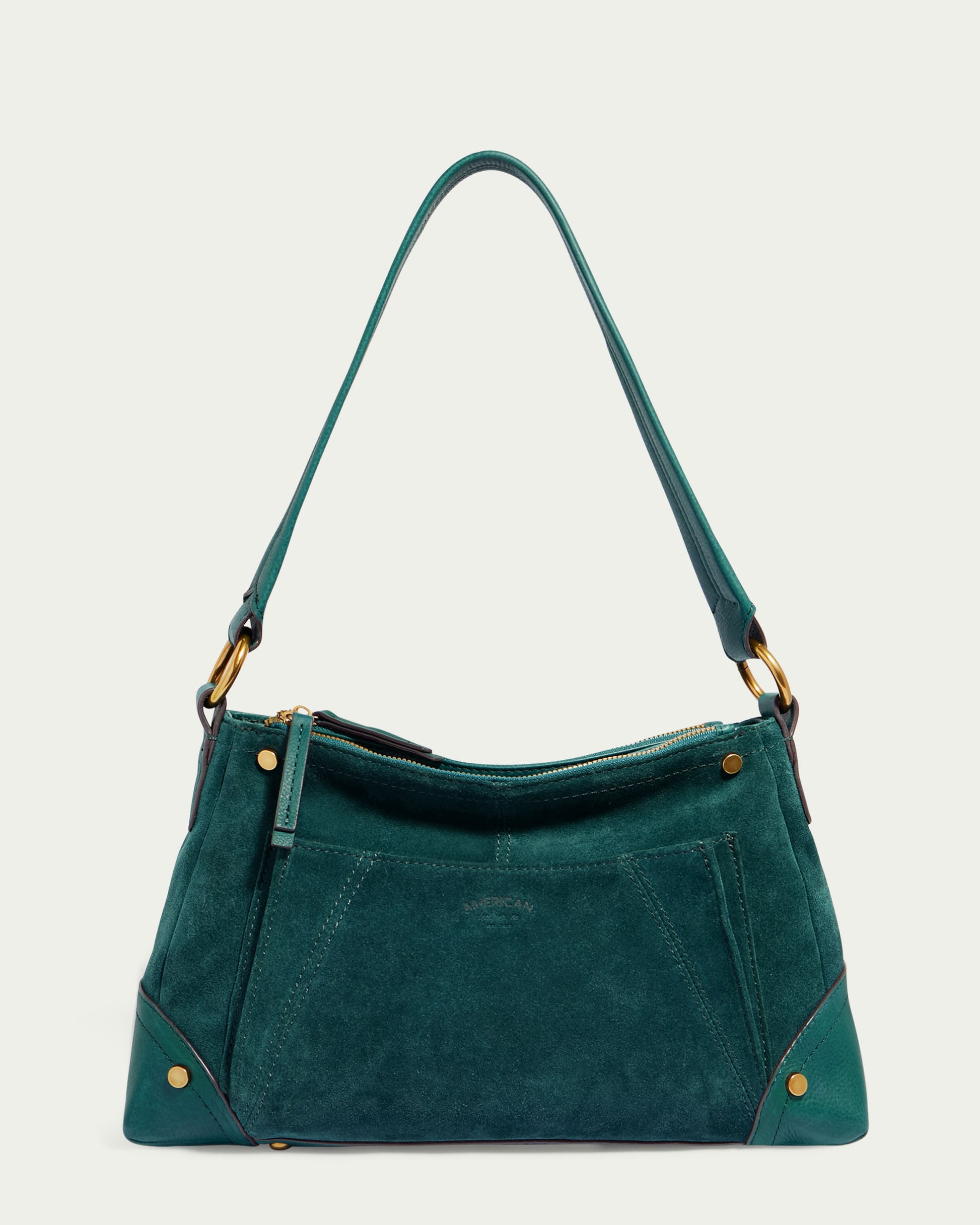 The Becket Triple Entry Shoulder from American Leather Co. is a green handbag made of Genuine Suede Leather with gold hardware. This traditional shoulder bag features a single strap, a front zip pocket, and decorative stitching. It boasts a structured, trapezoidal shape with metallic accents on the corners for an overall sleek and stylish design.