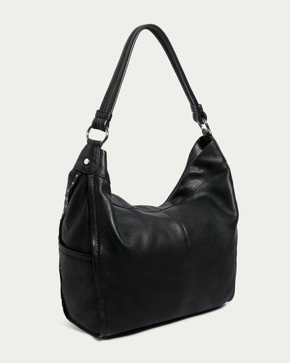 Introducing the Locke Ziptop Studded Hobo by American Leather Co., a sophisticated black genuine leather handbag. It features a sleek, minimalist design with silver hardware and a single shoulder strap. The exterior showcases a smooth texture accented by subtle stitching. Set against a plain light background, this stylish bag exudes elegance and modernity.