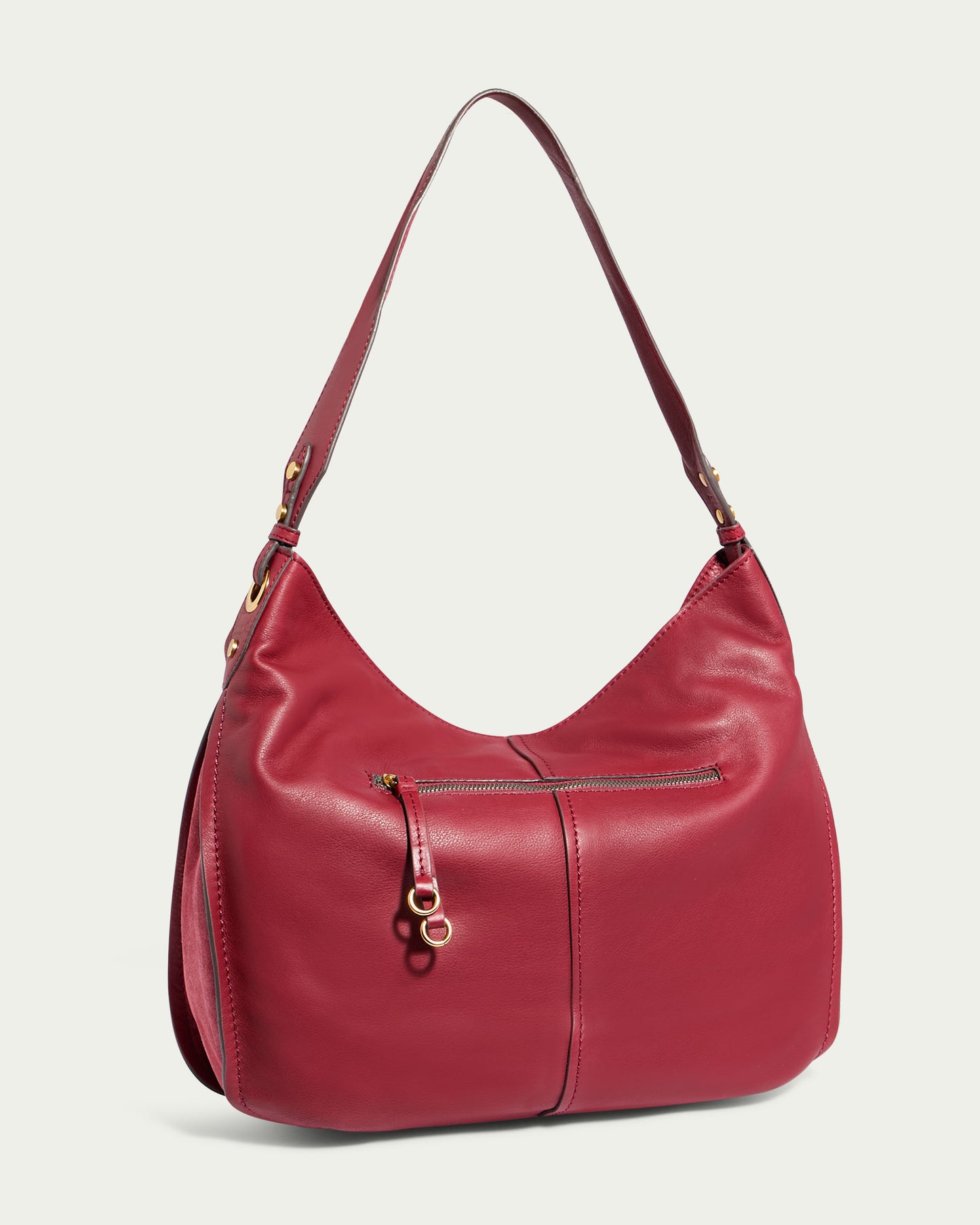 The Summit Large Top Zip Hobo by American Leather Co. is a red Genuine Leather shoulder bag with a single strap. It features a front zipper pocket with gold hardware and a zippered main compartment. The design is sleek and minimalist, making it suitable for both casual and formal use.