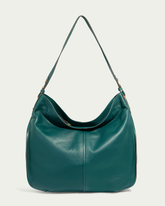 The Summit Large Top Zip Hobo by American Leather Co. is a sleek, forest green shoulder bag with a curved shape and an adjustable strap. Crafted from genuine leather, it showcases subtle stitching, a small embossed logo, and a zippered main compartment. The bag’s simple yet elegant design makes it both stylish and functional.