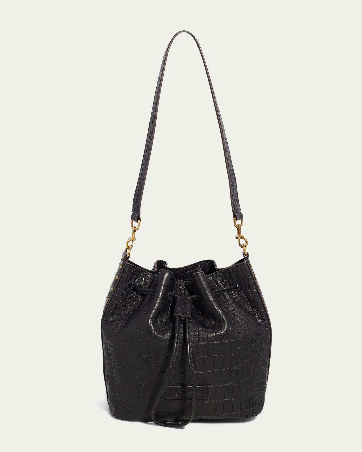 The Aden Drawstring Shoulder by American Leather Co. is a black leather hobo bag with a crocodile pattern, featuring drawstring closure, padded shoulder strap, and gold-tone hardware for a stylish and elegant look.