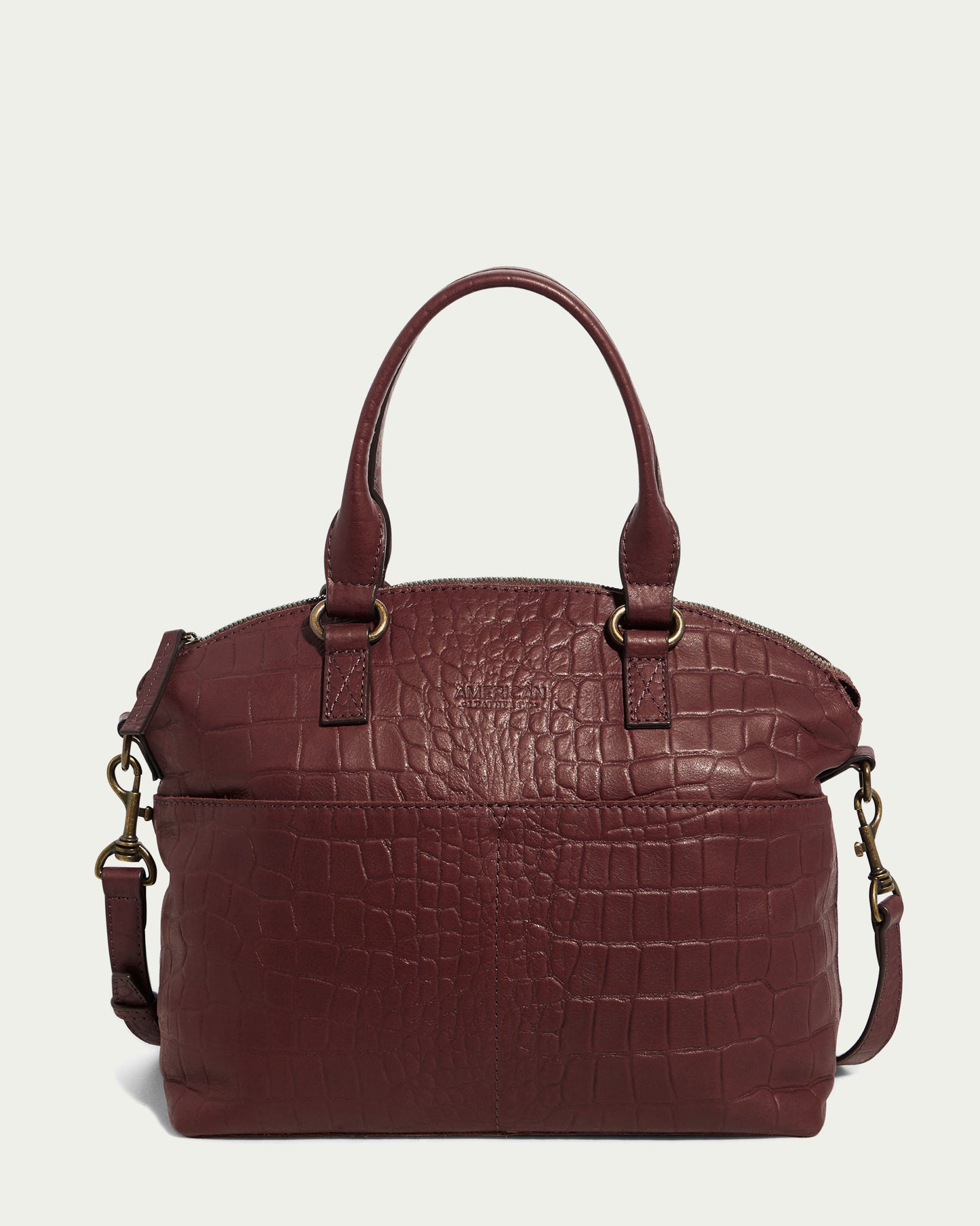 The elegant Carrie Dome Satchel from American Leather Co. features a maroon crocodile pattern, made of genuine leather. It has two sturdy handles, an adjustable crossbody strap with brass hardware, and a zippered compartment for functionality.