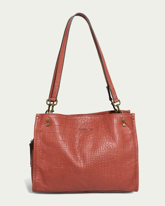 Introducing the Lenox Triple Entry Satchel by American Leather Co., a textured red-brown bag featuring a sophisticated crocodile skin pattern and twin shoulder straps. Made from Genuine American Leather, it includes elegant gold-tone hardware accents, making it perfect for everyday use.