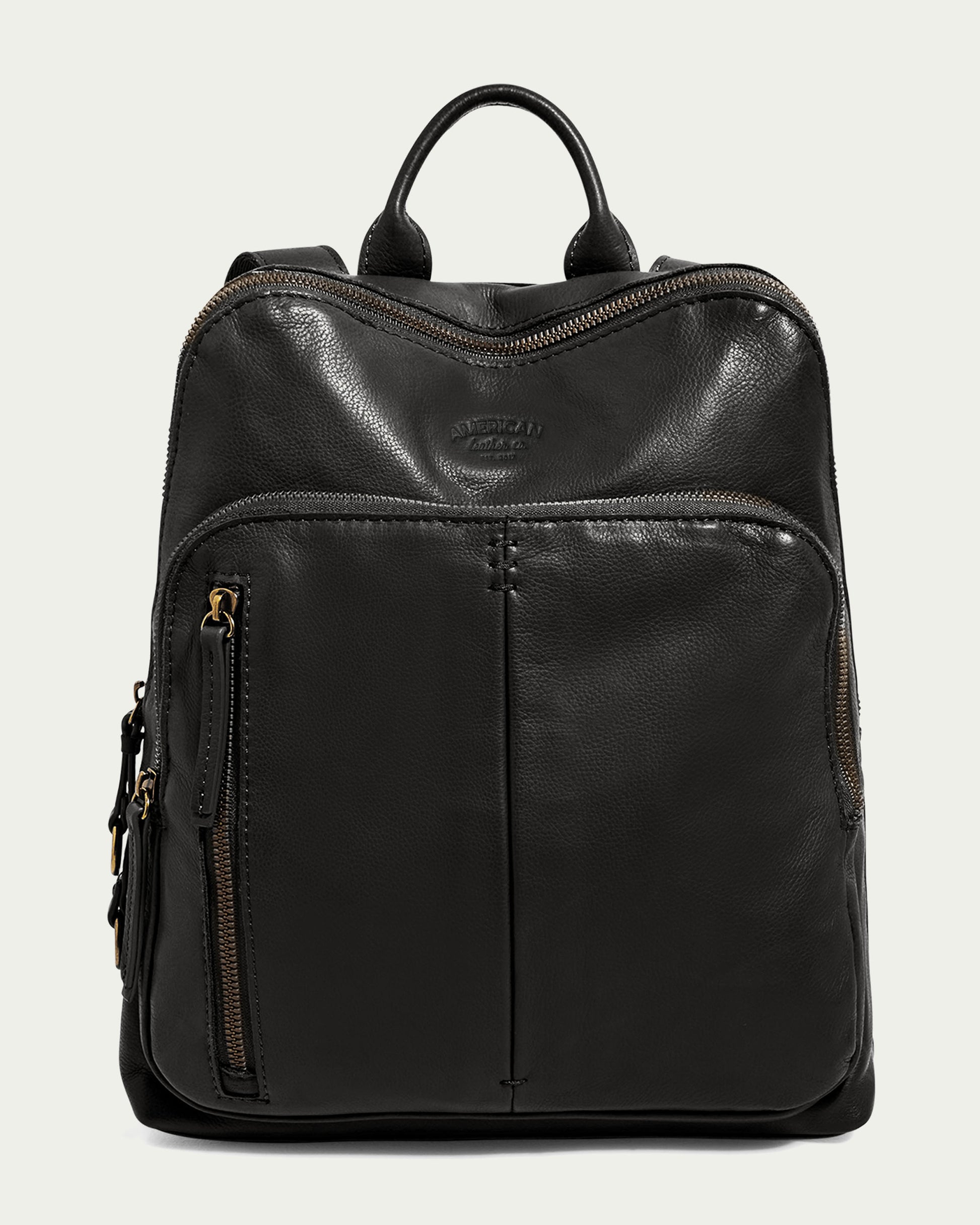 The Cleveland Backpack by American Leather Co. is a sleek black leather backpack made from genuine American leather. It showcases a smooth texture, adjustable back straps, a front zippered pocket, and a top handle, all set against a plain light background.