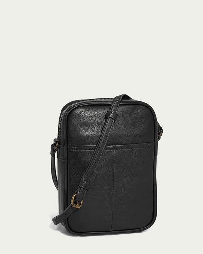 Introducing the Cleveland Large NS Crossbody from American Leather Co., a minimalist black leather bag crafted from genuine American leather. It features a slim adjustable strap, front pocket, and top zipper closure, elegantly standing upright against a white background.