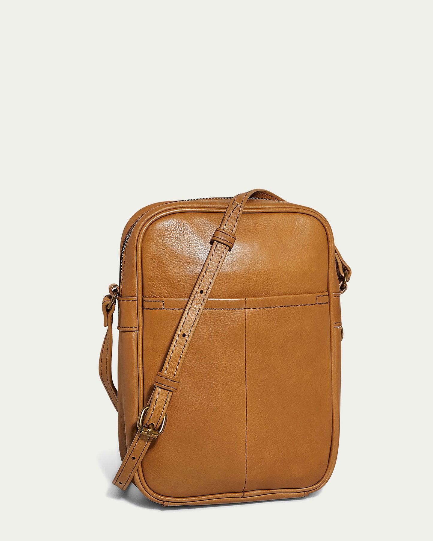 The Cleveland Large NS Crossbody by American Leather Co. is crafted from genuine leather with a smooth finish. It includes an adjustable crossbody strap and a front pocket for easy access.