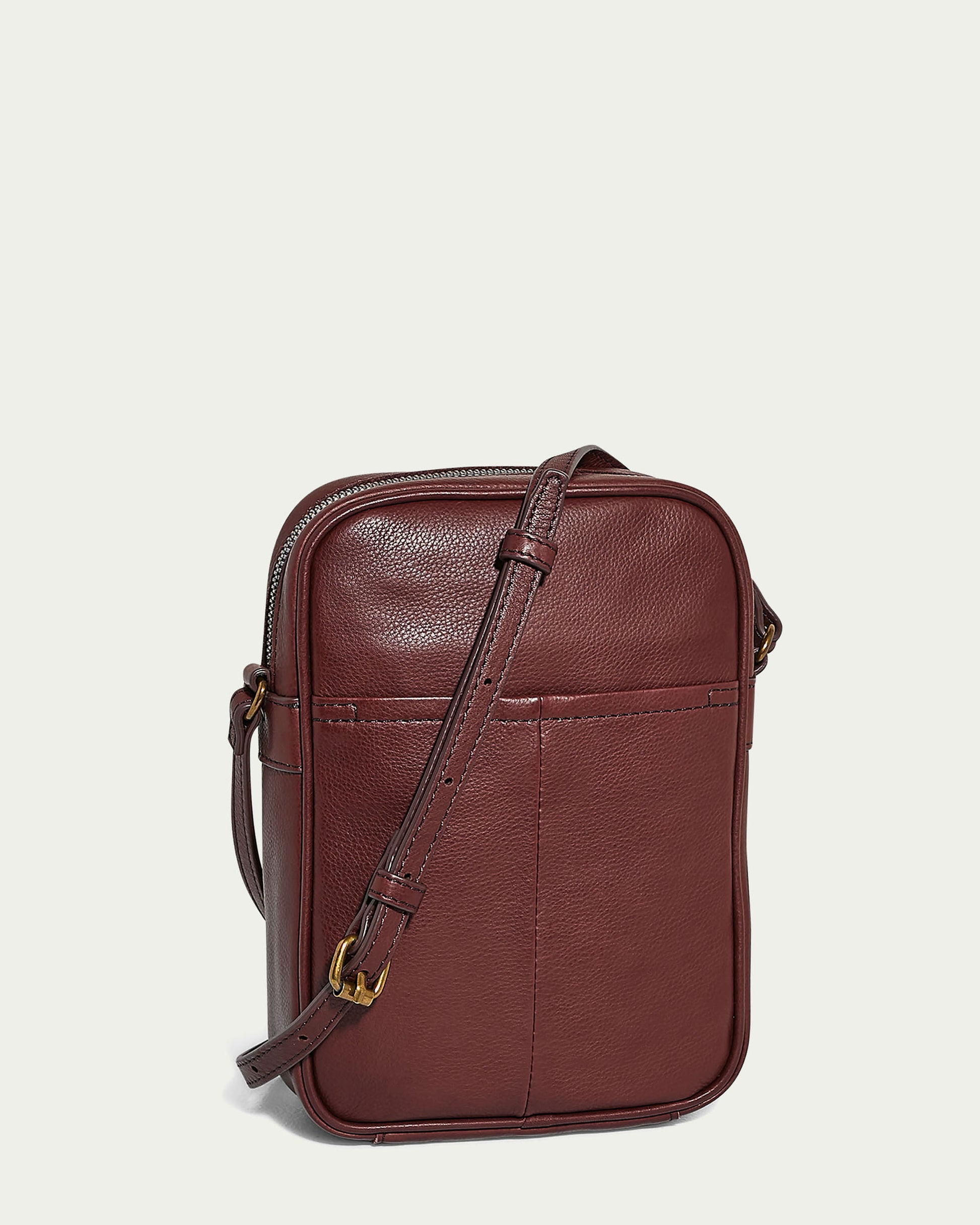 The Cleveland Large NS Crossbody from American Leather Co. is a rectangular brown leather bag made of genuine American leather. It has an adjustable strap, a front pocket, and gold-toned hardware, offering both style and practicality.