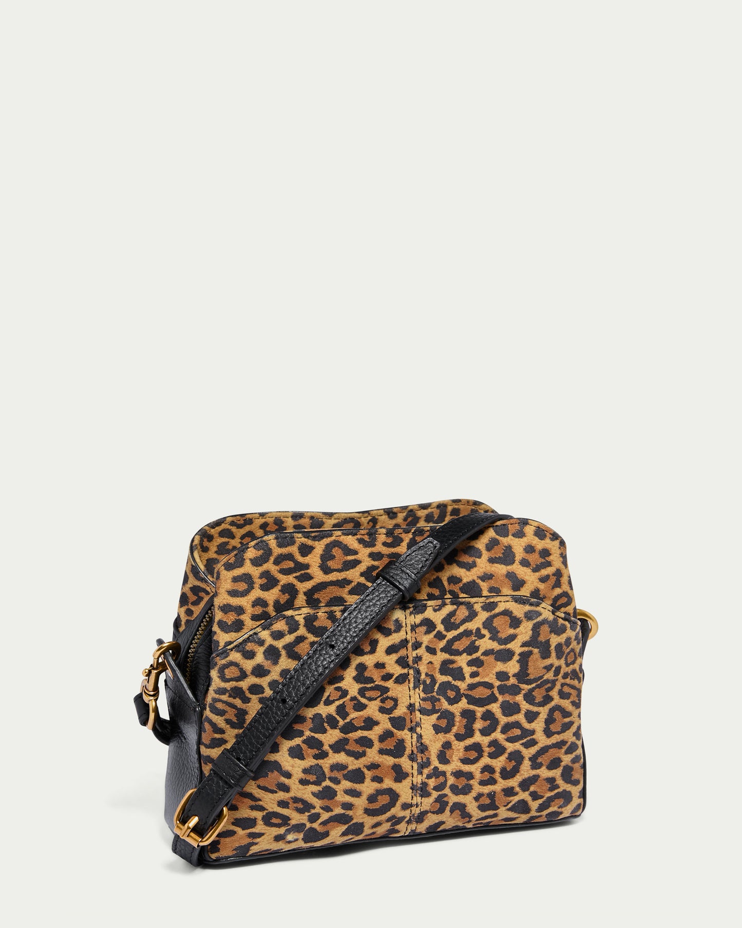 Introducing the Tulip Triple Entry Crossbody by American Leather Co., featuring a chic leopard print design. This genuine leather bag showcases a black adjustable strap and elegant gold buckle accents, all elegantly displayed against a plain white background. Its structured shape is enhanced with refined front stitching details.