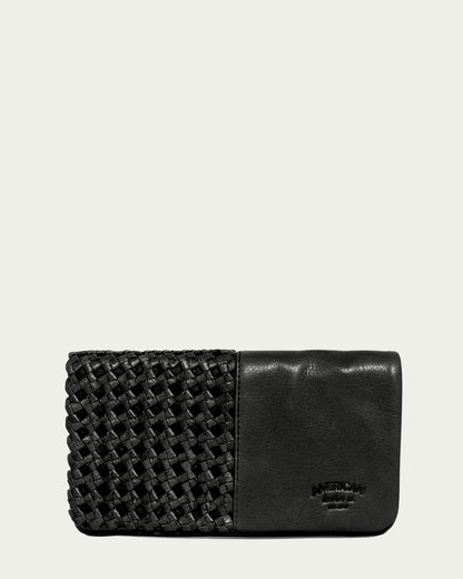 Introducing the Webster Woven Bifold Wallet by American Leather Co., a stylish black leather accessory featuring a textured woven pattern on one side and smooth leather on the other. Inside, it offers convenient credit card slots for organization. The brand name is subtly embossed in small letters on the lower right corner. It is displayed against a plain off-white background.