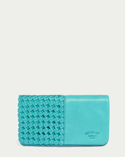 A Blue Lagoon Webster Woven Bifold Wallet by American Leather Co., showcasing woven details on the left and a smooth, supple leather surface on the right, with the brand name embossed on the lower right corner.