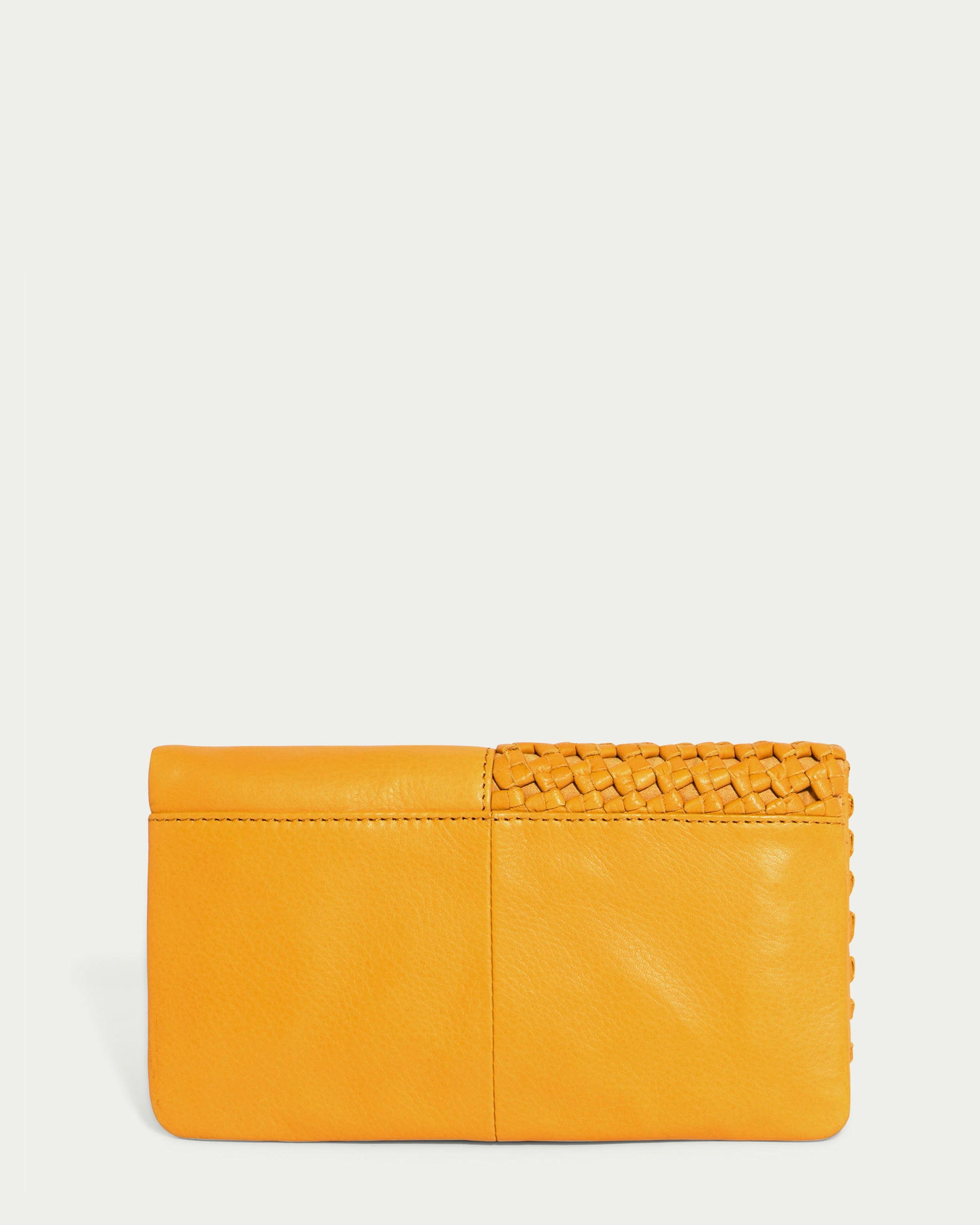 Introducing the Webster Woven Bifold Wallet by American Leather Co., a mustard yellow leather accessory that combines elegance and style. Crafted from supple leather, it features a smooth texture complemented by a woven design on one side, adding a sophisticated touch to its flap design.