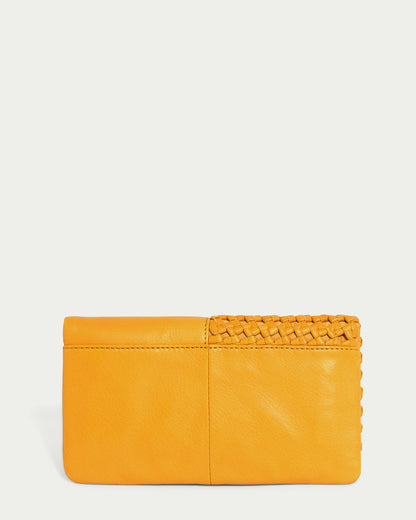 Introducing the Webster Woven Bifold Wallet by American Leather Co., a mustard yellow leather accessory that combines elegance and style. Crafted from supple leather, it features a smooth texture complemented by a woven design on one side, adding a sophisticated touch to its flap design.