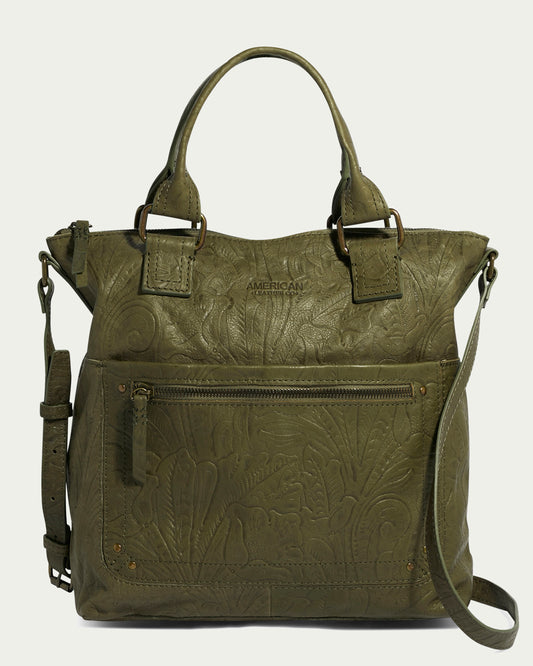 The Jamestown Tote by American Leather Co. is a chic olive green handbag made from authentic American leather with embossed floral patterns. It includes two top handle carryalls, an adjustable shoulder strap, a front zipper pocket, and metallic accents, with the brand's logo subtly embossed on the upper front.