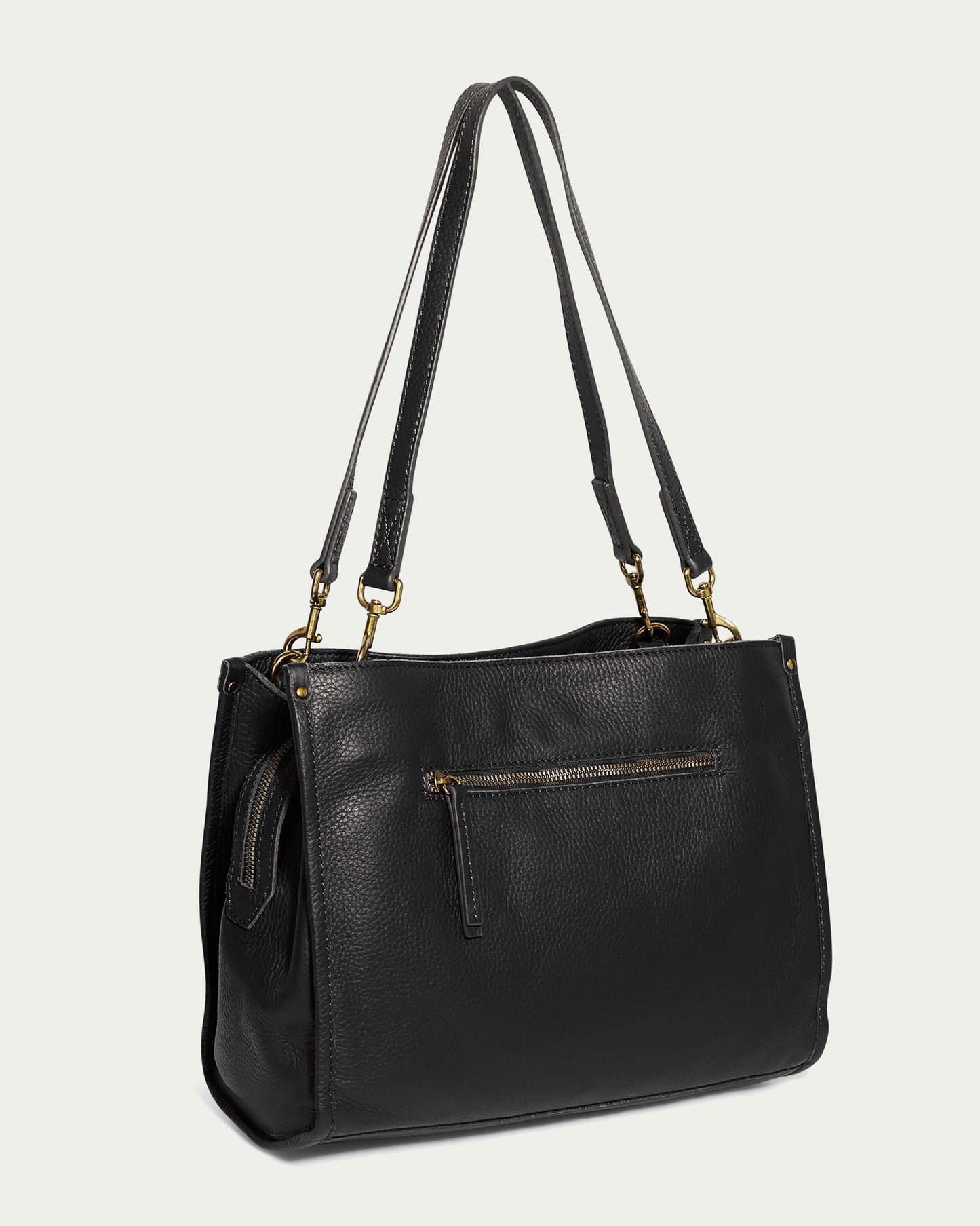 Introducing the Lenox Triple Entry Satchel by American Leather Co., a chic and stylish black handbag crafted from genuine American leather. It features two long shoulder straps, a front zippered pocket, and is adorned with elegant gold-toned hardware accents, making it the perfect everyday essential for a fashionable look.