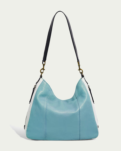 Explore the Austin Shoulder by American Leather Co., a chic handbag made from authentic American leather. Showcasing a soft blue leather front, white side panels, and a black shoulder strap, this casual piece features understated stitching and metal clasps. Its design strikes a balance between simplicity and elegance.