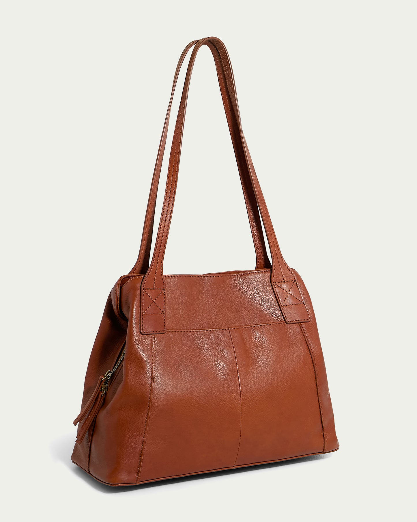 Introducing the Ada Triple Entry Tote by American Leather Co. - a stylish brown leather bag with a smooth finish and double handles. This chic tote features a structured, slightly trapezoidal shape, reinforced stitching at the handles' base, and a side view that reveals a zippered compartment with a convenient zipper pull for enhanced interior organization.