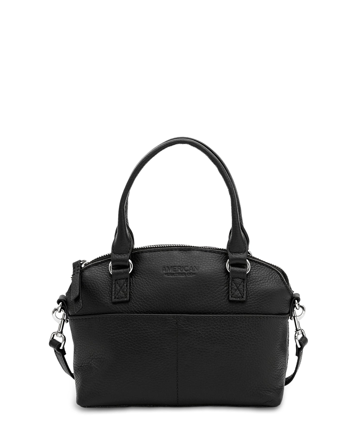 A small black pebble leather Carrie Mini Dome Crossbody from American Leather Co. with two short handles and a detachable, adjustable shoulder strap. The handbag features silver hardware and a zippered closure, with the brand name "AMERICAN" embossed on the front, highlighting its genuine leather craftsmanship.