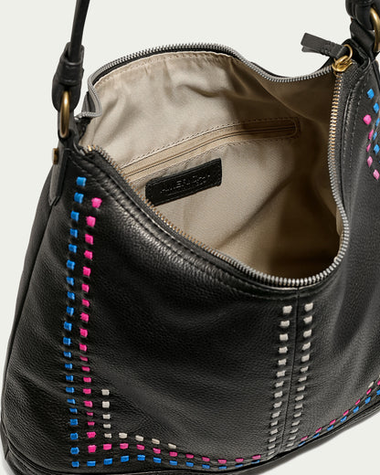 An American Leather Co. Evelyn Hobo handbag, crafted from genuine leather, is featured open to reveal its beige interior and spacious design. This luxury hobo bag boasts a zipper closure and vibrant stitch detailing in blue, pink, and white along the sides. The straps are securely fastened with brass rings.