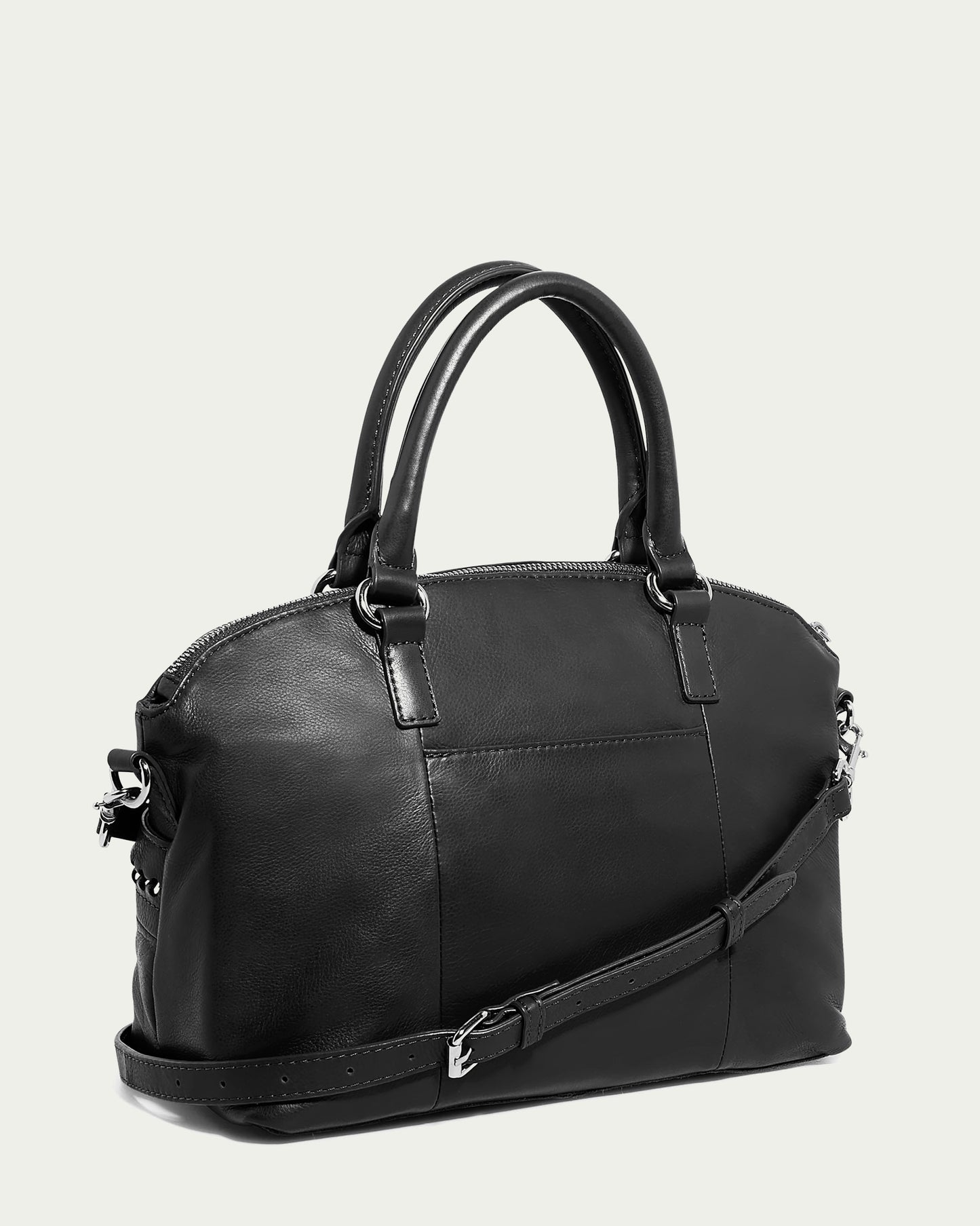 Introducing the Janssen Dome Satchel by American Leather Co.: a sophisticated black genuine leather dome satchel featuring sturdy handles and a detachable shoulder strap. This bag boasts a sleek, structured design complemented by silver-tone hardware, and is beautifully accentuated on a light gray background to emphasize its elegant and modern aesthetic.