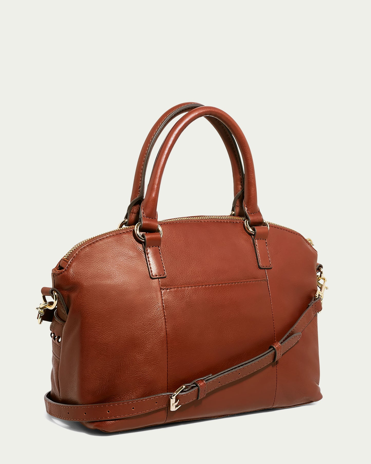 The Janssen Dome Satchel from American Leather Co. is a brown leather handbag featuring double handles and a detachable shoulder strap. With its zippered closure and minimal stitching, this genuine leather bag stands out against a simple light background, radiating elegance and style.