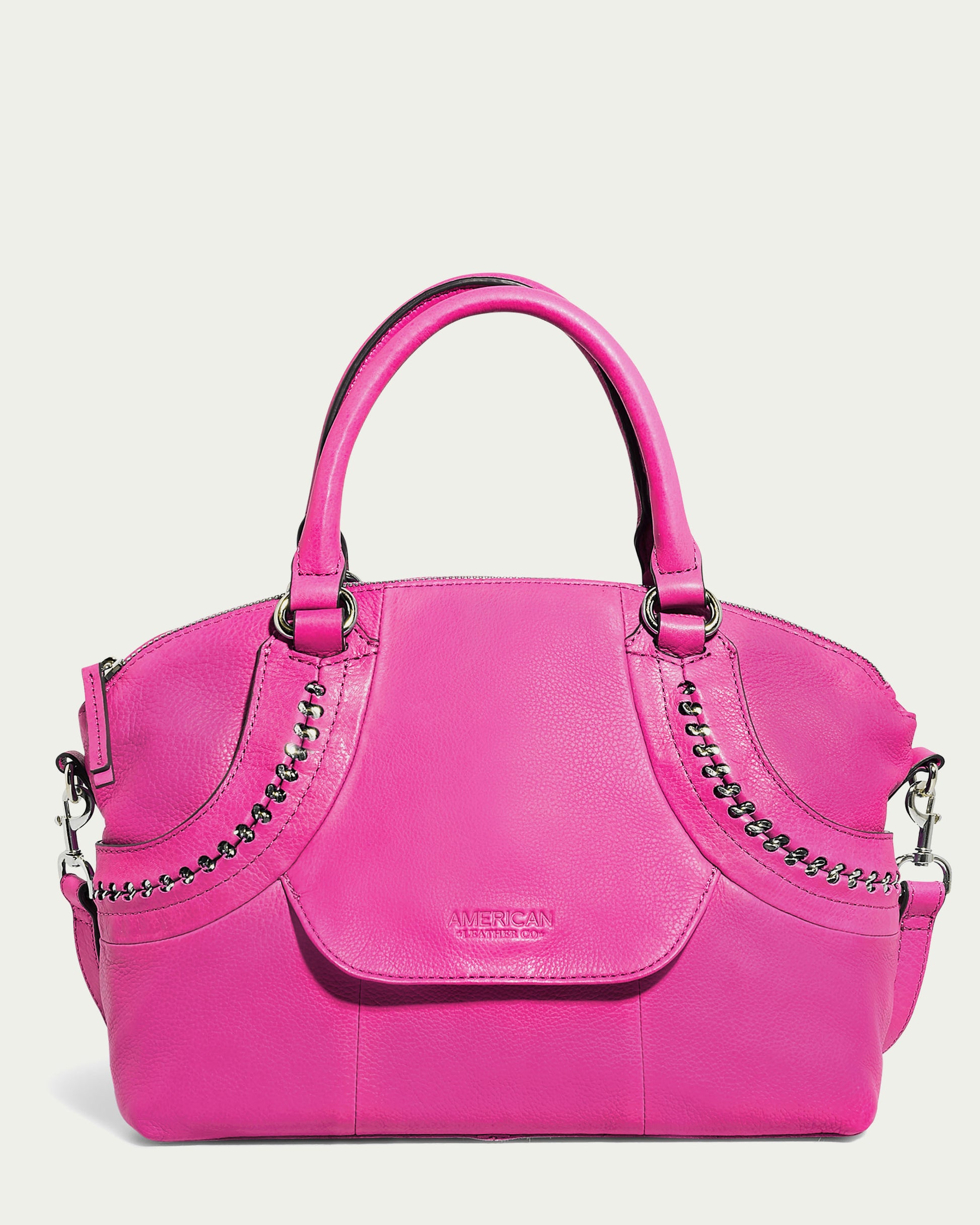 Explore the Janssen Dome Satchel by American Leather Co., a striking pink leather bag adorned with silver chain details on the front. Perfect for daily use, it offers two robust handles and a removable shoulder strap, highlighted by an embossed logo at the center for added elegance.