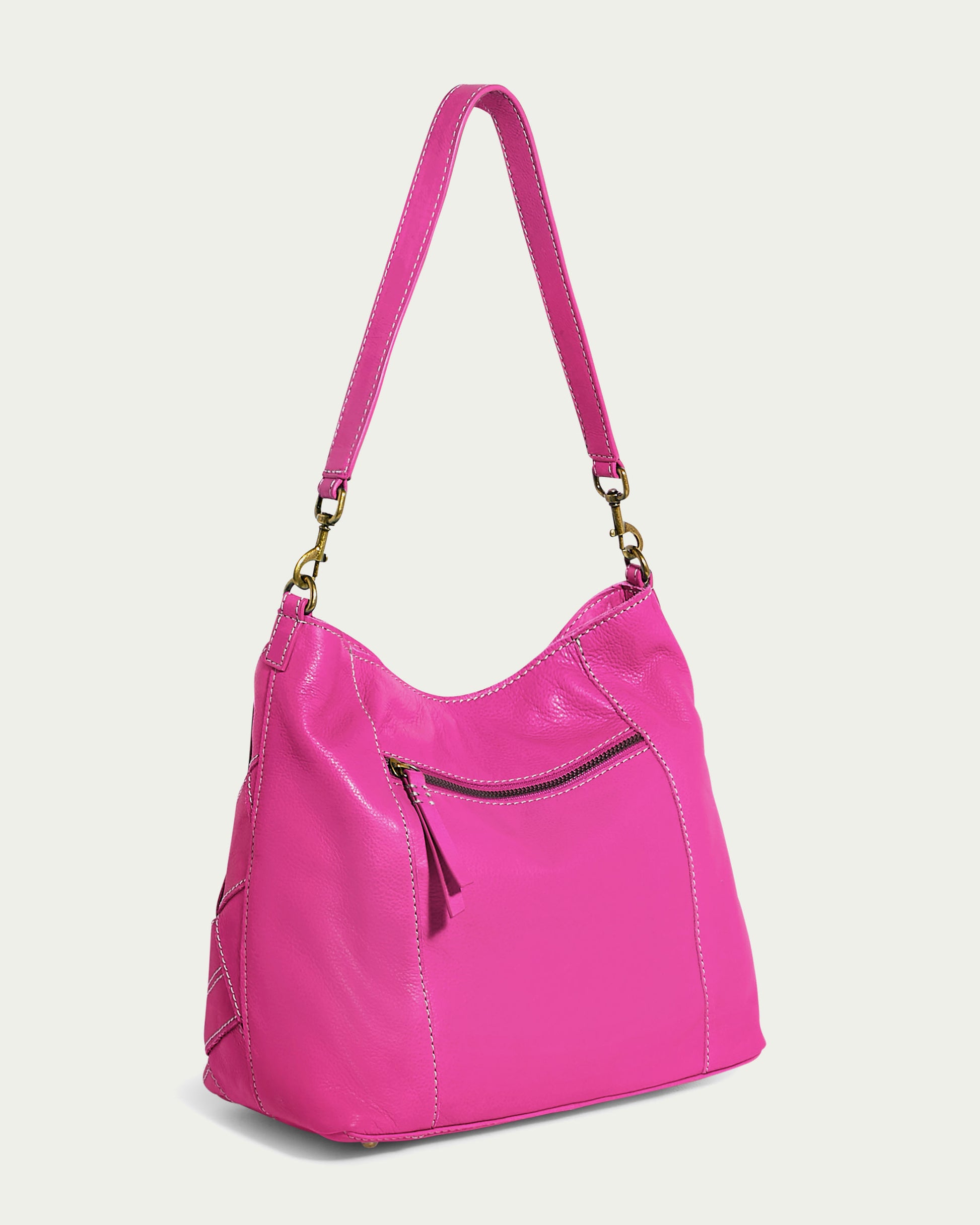 A vibrant Mercer Shoulder handbag from American Leather Co., meticulously crafted from genuine leather in a striking pink hue. It boasts a detachable single shoulder strap, a front zipper pocket, and intricate stitch detailing. The bag is subtly curved at the top and features gold-tone hardware that connects the strap to the bag.