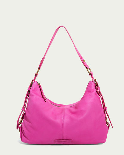 The Thayer Perfect Hobo from American Leather Co. is a bright pink shoulder bag with a single strap and gold-tone hardware, featuring a U-shaped silhouette and decorative side tassels. Made from genuine leather, this stylish purse stands out against a solid white background.