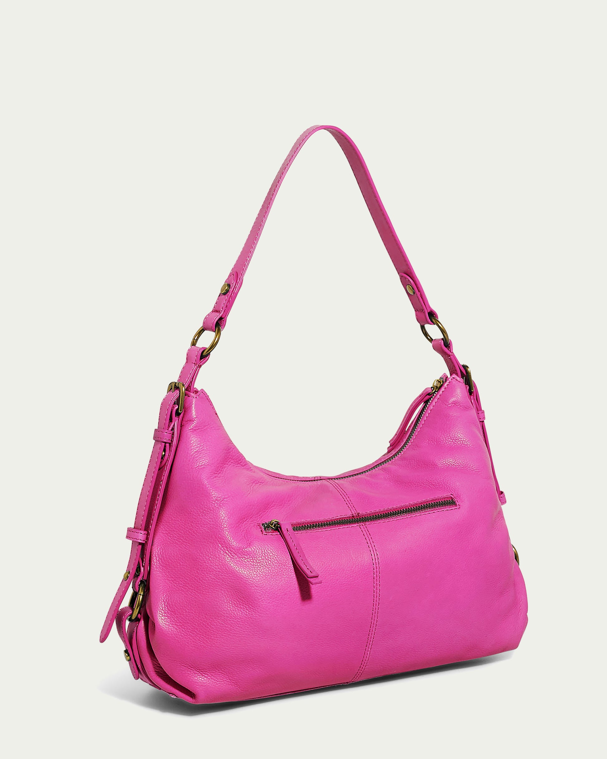 A vibrant hot pink Thayer Perfect Hobo shoulder bag from American Leather Co., crafted from genuine leather. The bag features a front zipper pocket with a tassel pull, gold-tone hardware, and an adjustable shoulder strap with buckle details on the sides. Its sleek and stylish design makes it a standout accessory.