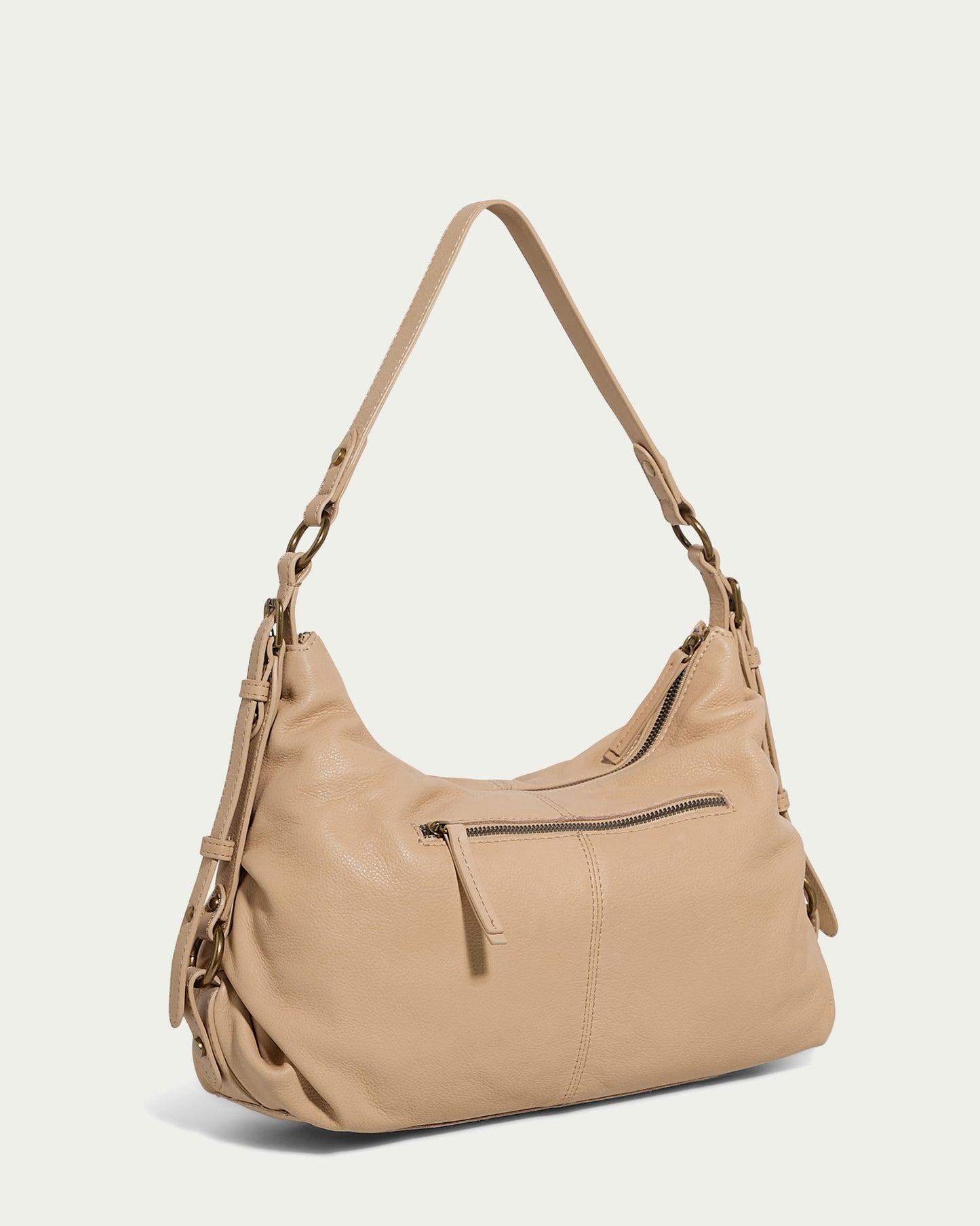 The Thayer Perfect Hobo by American Leather Co. is a tan handbag made from genuine leather, highlighting a sleek, curved design and featuring a single shoulder strap. It includes a front zipper pocket and metallic chain accents on the strap attachments, standing out beautifully against a light background.