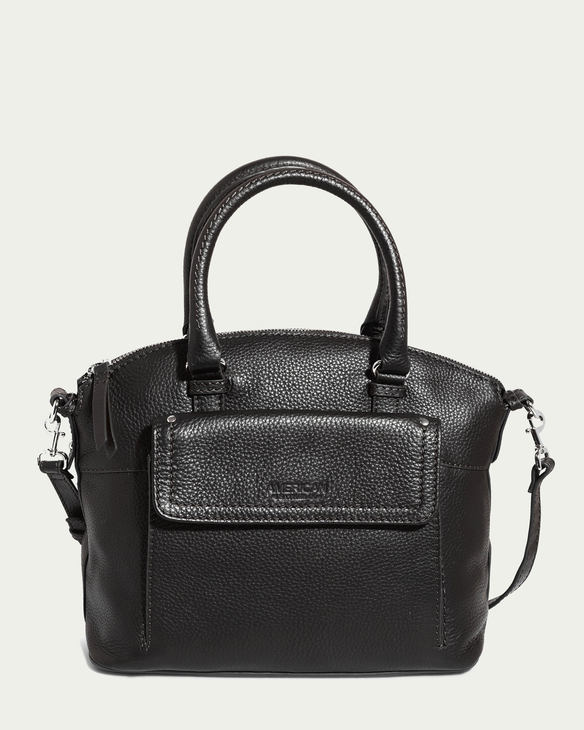 A Black Pebble Vona Convertible Dome Satchel from American Leather Co., crafted in genuine leather with a textured finish, featuring two short handles and a detachable shoulder strap. The bag includes a front flap pocket with the brand's logo embossed on it, and is detailed with silver-tone hardware attachments.