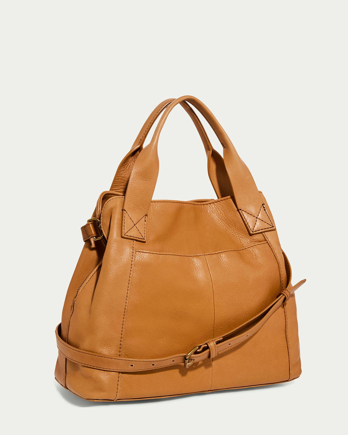 The Ada Triple Entry Satchel by American Leather Co. is a tan structured satchel crafted from genuine American leather. It features short handles, an adjustable crossbody strap, stitched details, and a sleek design against a plain background.