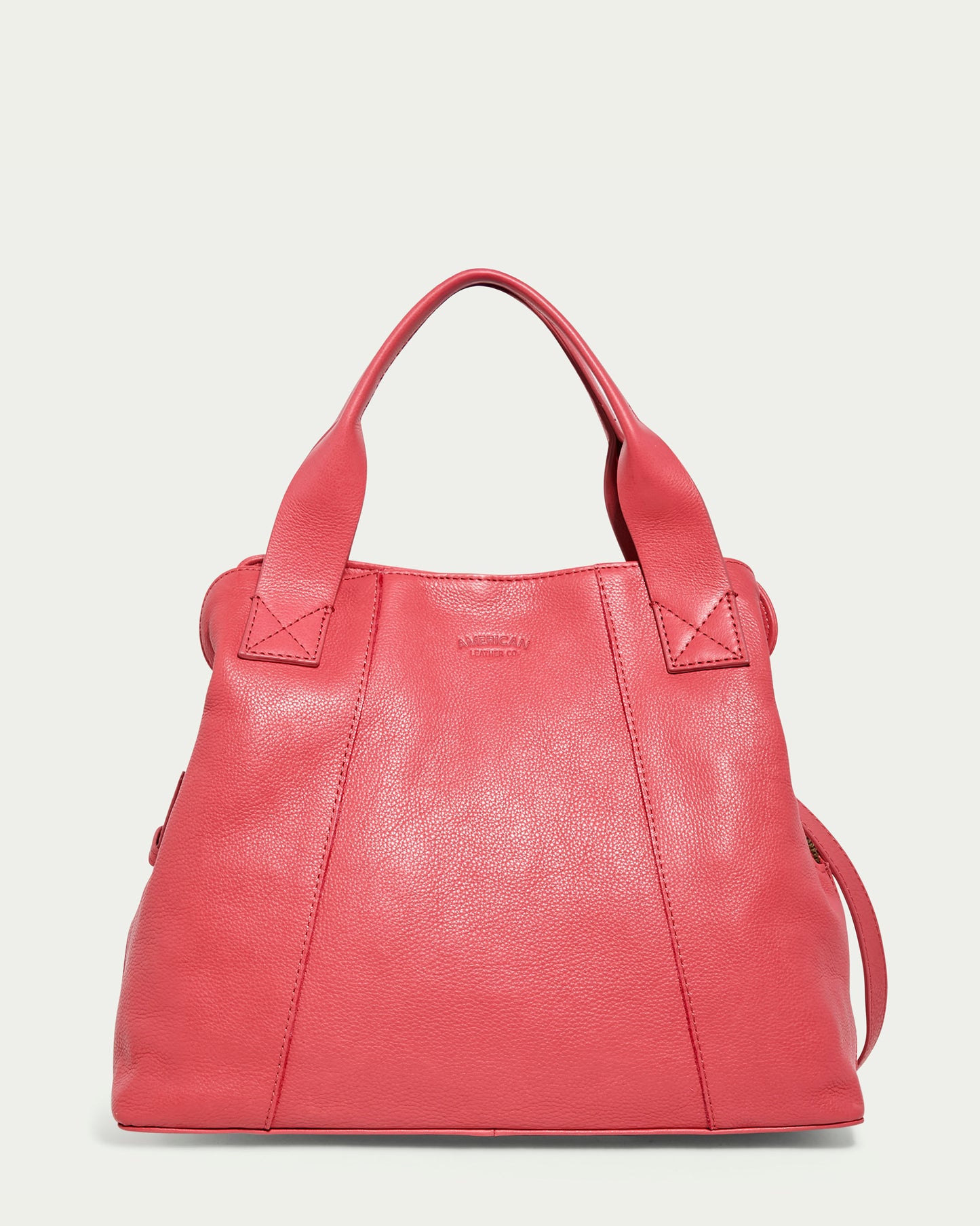 The Ada Triple Entry Satchel by American Leather Co. is a French Rose genuine leather handbag with two sturdy handles and a sleek, structured design. It features subtle stitching and a slightly pebbled texture against a pristine white background.