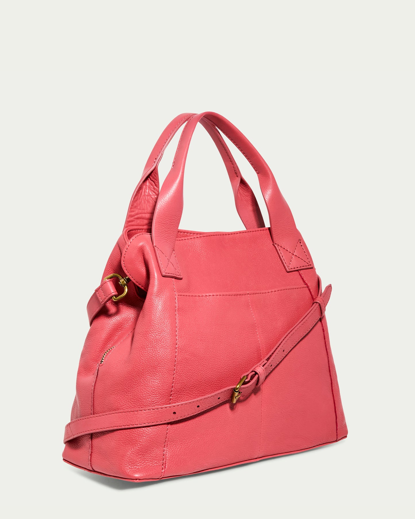 The Ada Triple Entry Satchel from American Leather Co. is a pink structured satchel made of genuine leather, featuring short handles, an adjustable shoulder strap with a metallic buckle, and visible stitching on a plain background.