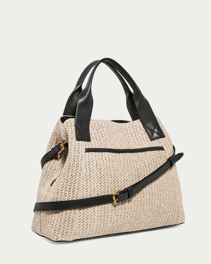 The Ada Triple Entry Satchel Raffia With Black by American Leather Co. is a beige woven handbag with black leather straps and accents, set against a light backdrop. This structured bag boasts gold buckle detailing, a sleek shape, handles, and an adjustable crossbody strap for versatile use.