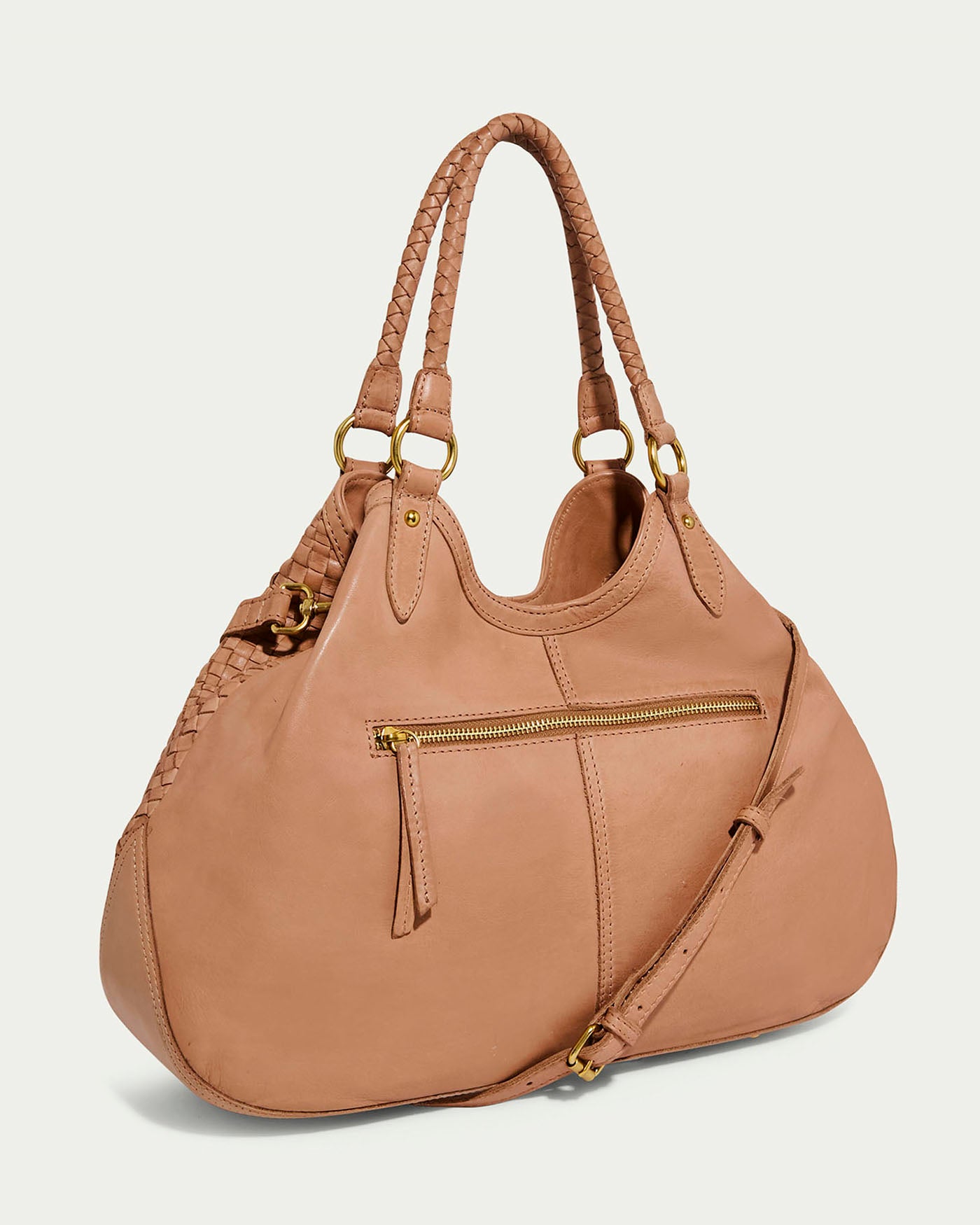 The Blair Convertible Tote by American Leather Co. is a tan woven handbag crafted from genuine leather, with braided handles and a detachable shoulder strap. It features a front zipper pocket and gold-tone hardware, including buckles and hooks, blending elegance with functionality.