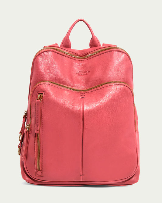 The Cleveland Backpack from American Leather Co. is in French Rose, made of genuine leather with a subtle texture. It features a top handle, adjustable back straps, and gold zippers on the main compartment, front pocket, and vertical side pocket; the brand name is embossed on the front.