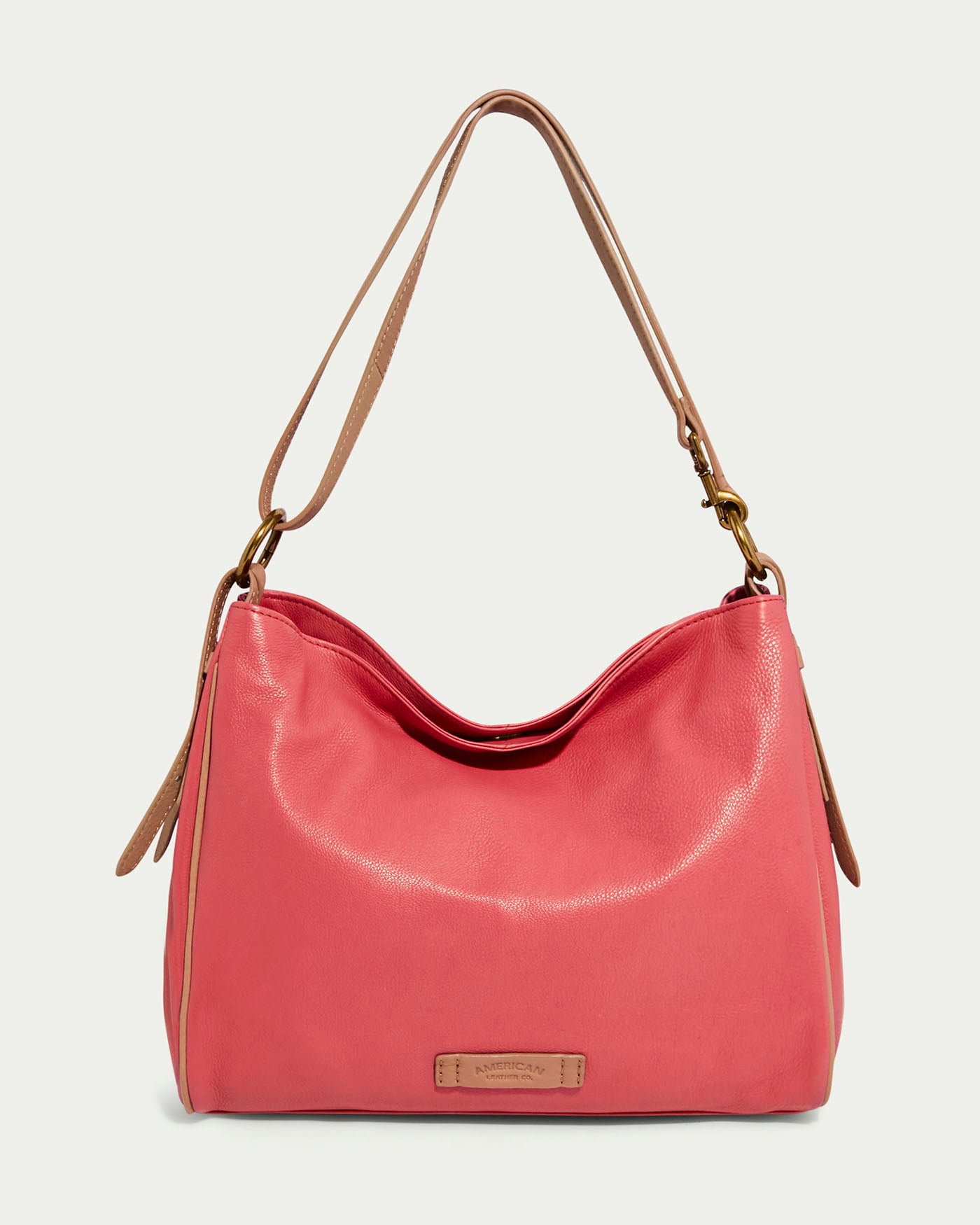 The Dean Double Entry Convertible Hobo by American Leather Co., in French Rose glove leather, features a wide, adjustable Nutmeg strap for comfort. Its relaxed, slouchy shape and subtle logo on the front lower center are elegantly complemented by gold-tone hardware.