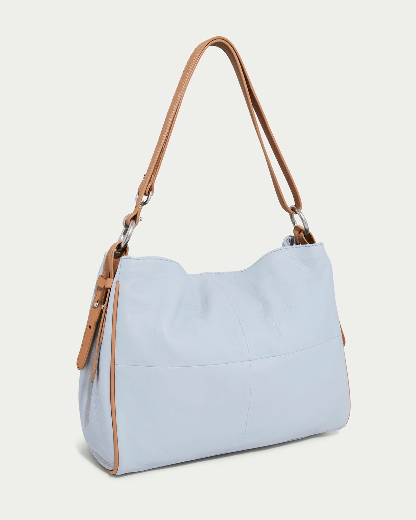 An American Leather Co. Dean Double Entry Convertible Hobo handbag, light blue with tan leather straps and metal accents, showcases a simple structured design with visible stitching and a soft-textured look against a plain light background.