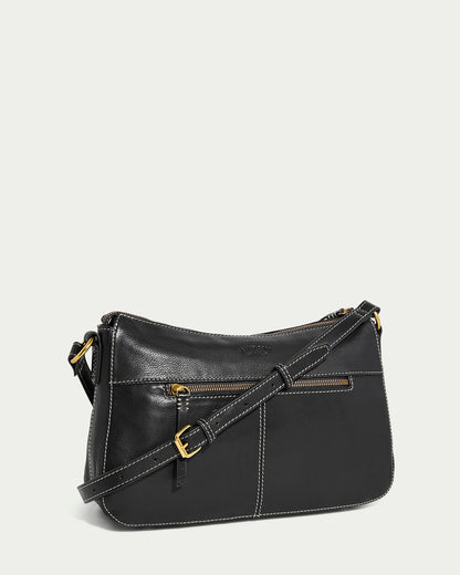 The American Leather Co. Holton Crossbody, made with sleek black glove leather, has a long adjustable strap and gold-tone hardware. Its elegant design highlights a front zipper pocket and visible stitching on a plain light background.